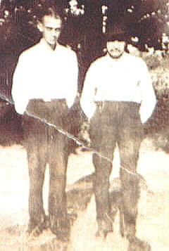 two men, younger man taller, older man with hat